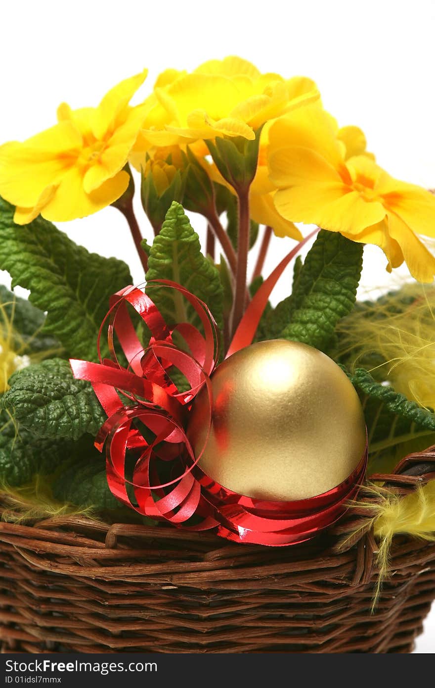 Golden egg with spring yellow flower for easter background.