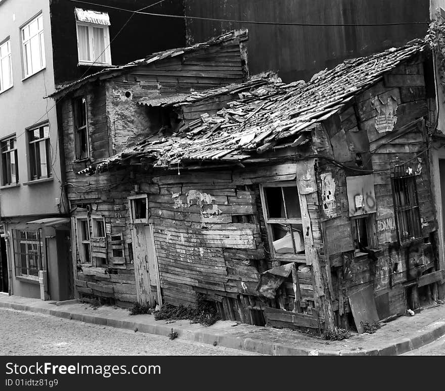 A decrepit shack wedged into the corner of a modern row of buildings in downtown Istanbul, Turkey. A decrepit shack wedged into the corner of a modern row of buildings in downtown Istanbul, Turkey