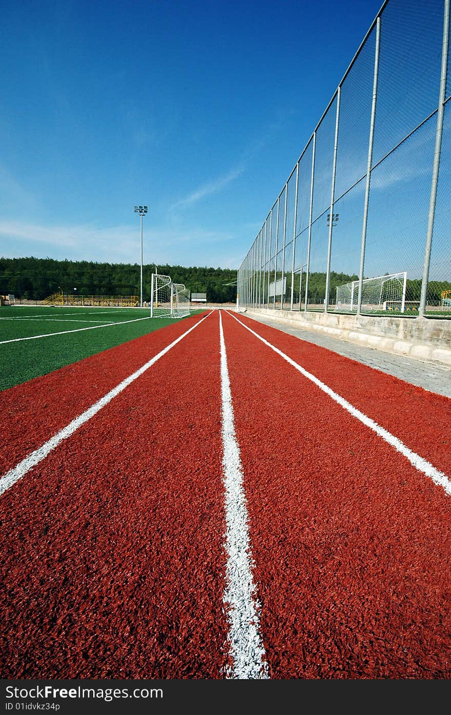 Running track and green football field. Running track and green football field