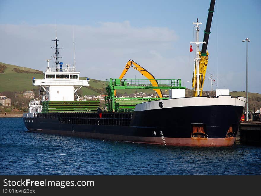 Cargo Ship Being Loaded At Dock. Cargo Ship Being Loaded At Dock.