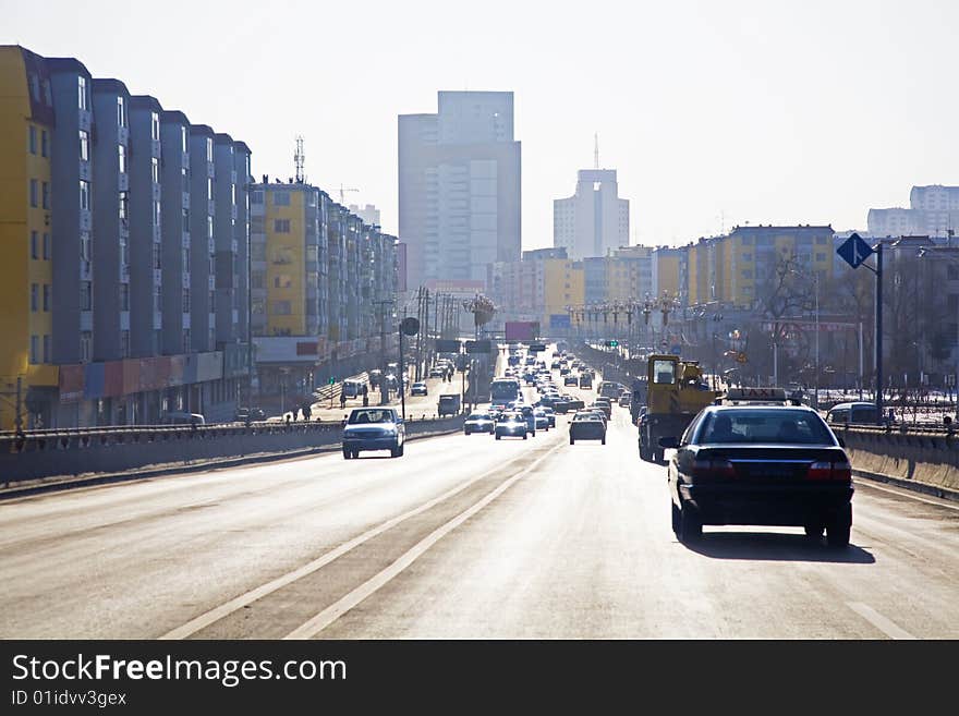 Road perspective with city traffic