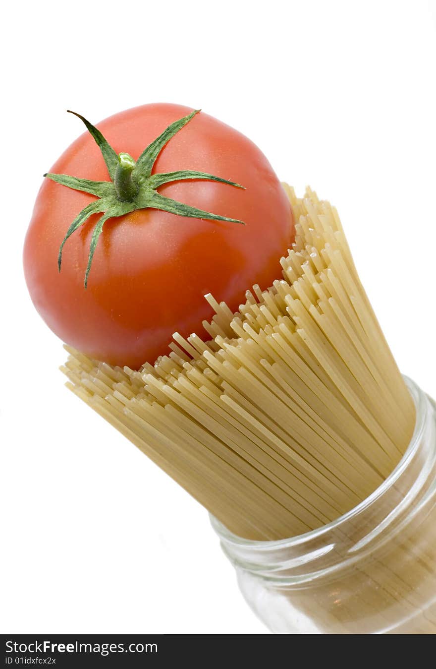 Spaghetti and mature tomato isolated on a white background. Spaghetti and mature tomato isolated on a white background