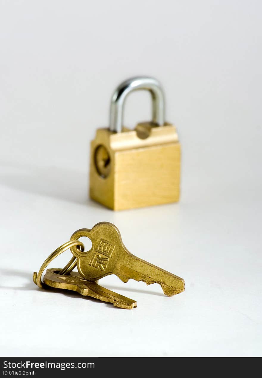 Key and lock of the wanted colour on white background