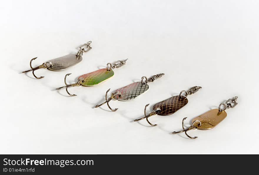 Spoon baits of the miscellaneous colour from metal with hook on white background