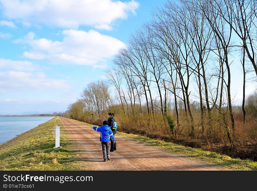 A woman with a child on the riverbank. A woman with a child on the riverbank.