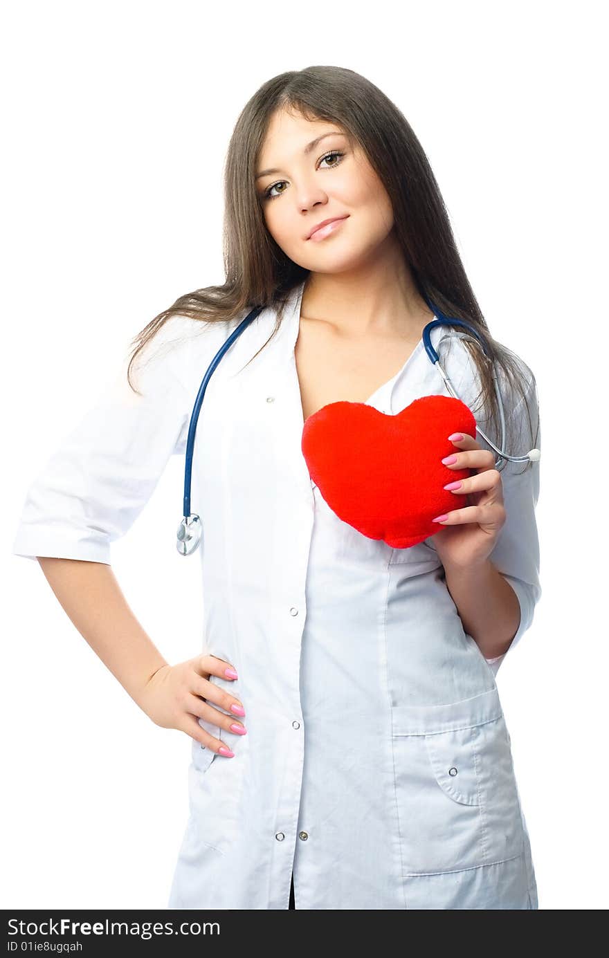 Young beautiful female cardiologist with a heart shaped pillow