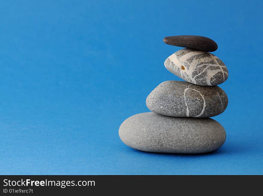 Spa stones on blue background