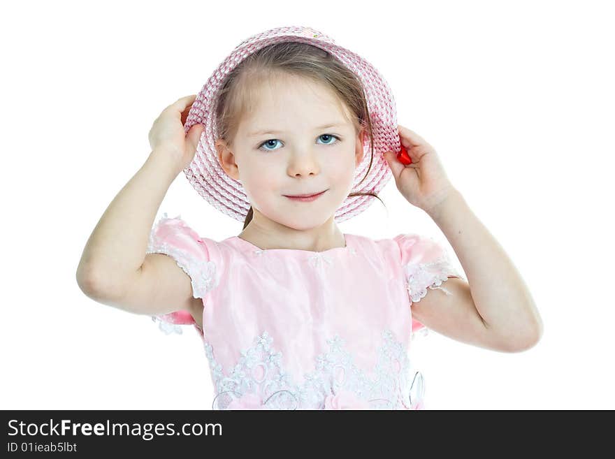 Portrait of little blond girl in pink holding her hat