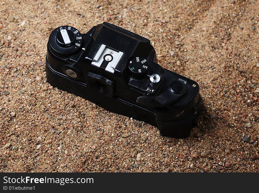 Film camera thrown to sand