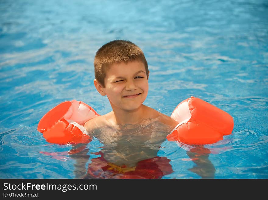 Boy swims in the pool