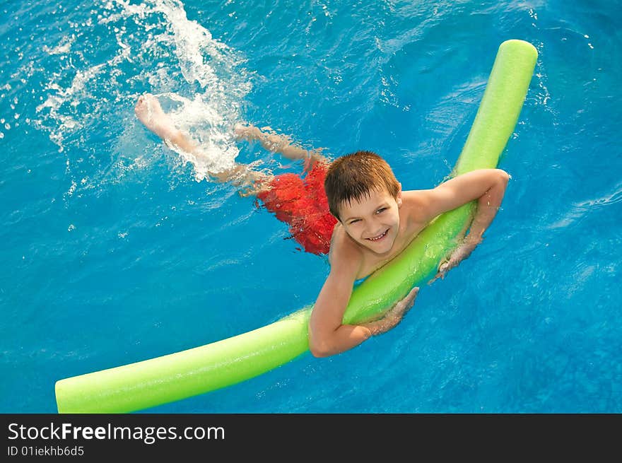 Young boy swims in the pool. Young boy swims in the pool