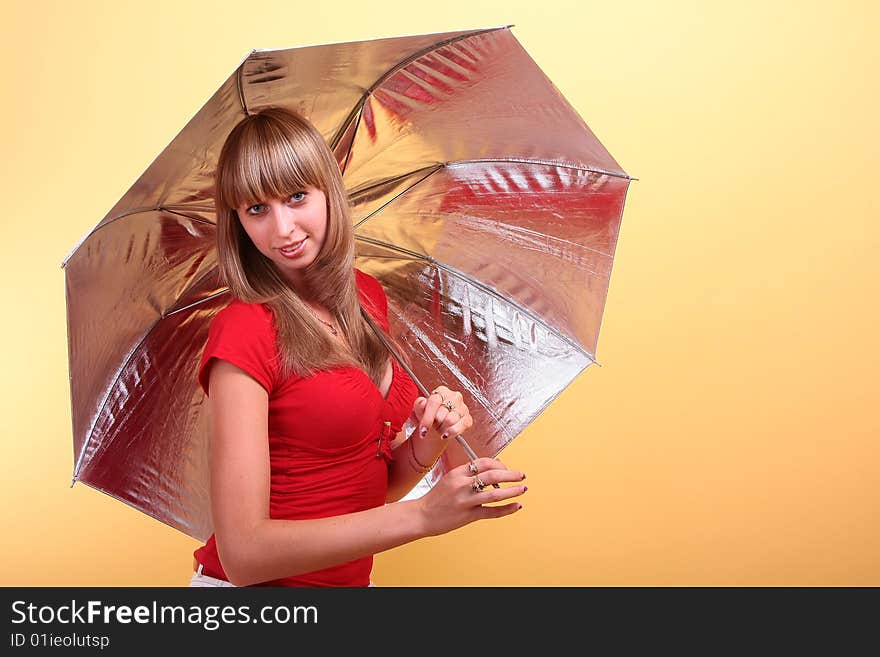 Beauty girl with umbrella on a yellow background