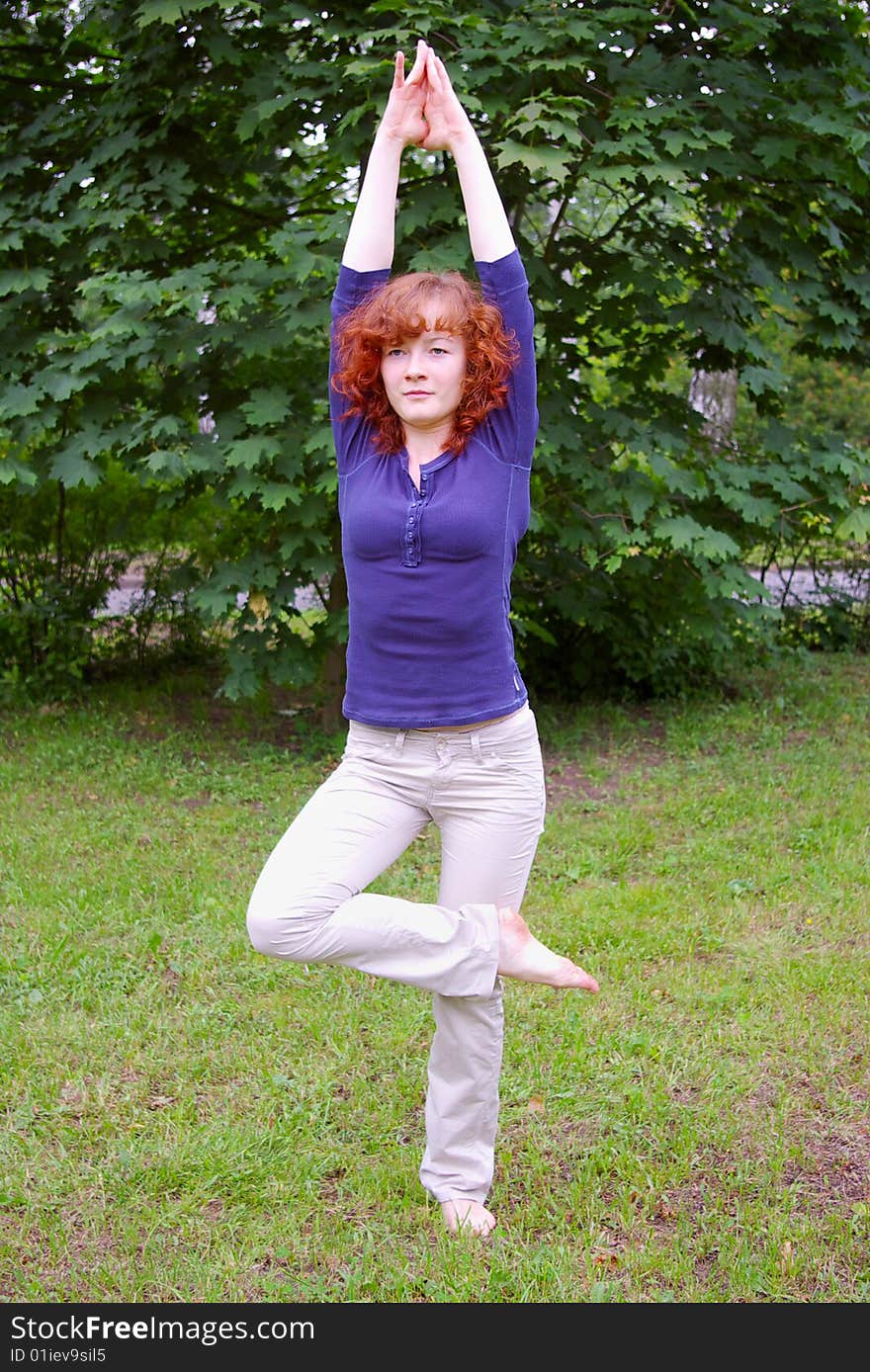 Young girl doing yoga on the nature