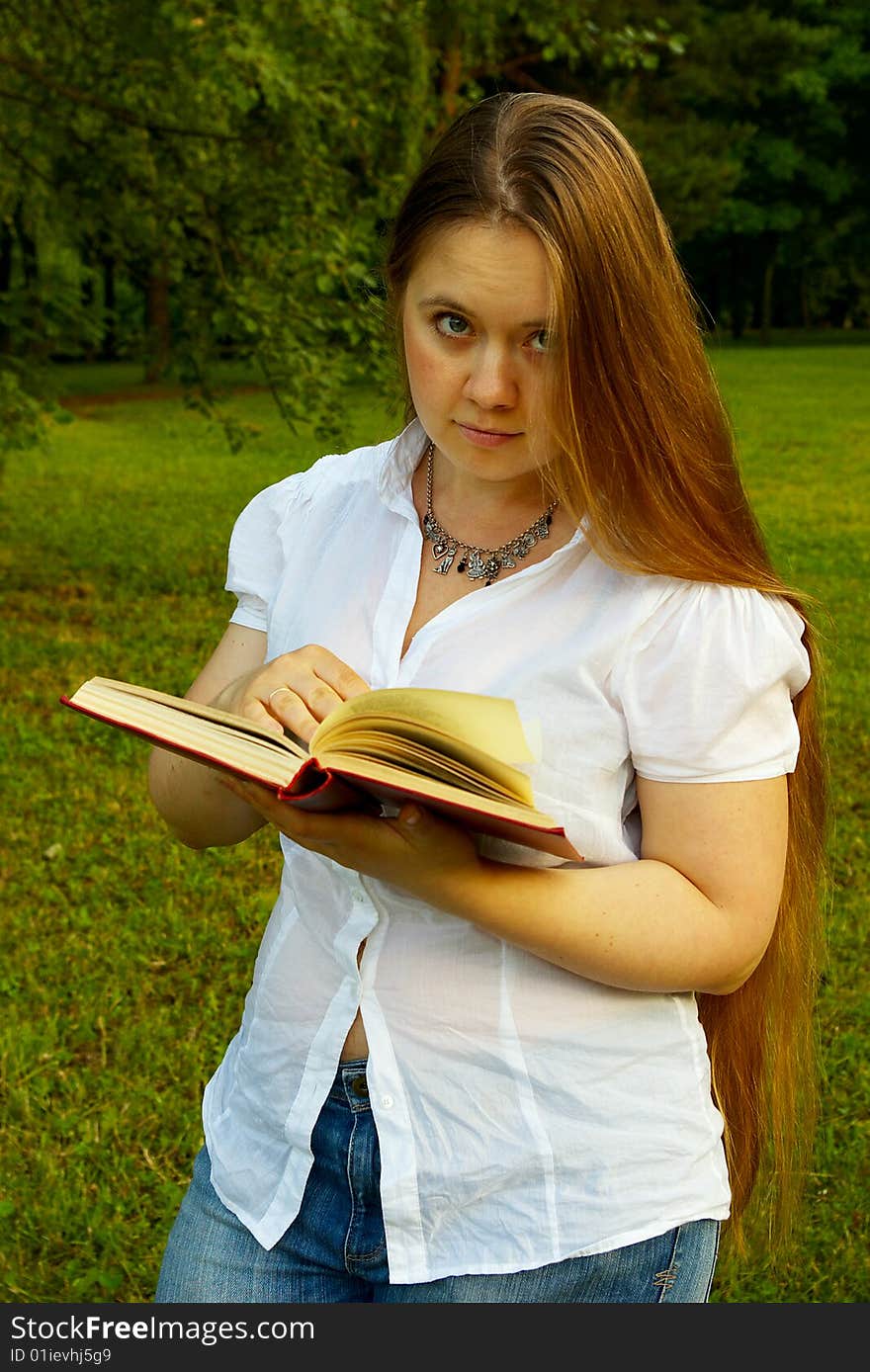 Blond girl standing with a book. Blond girl standing with a book