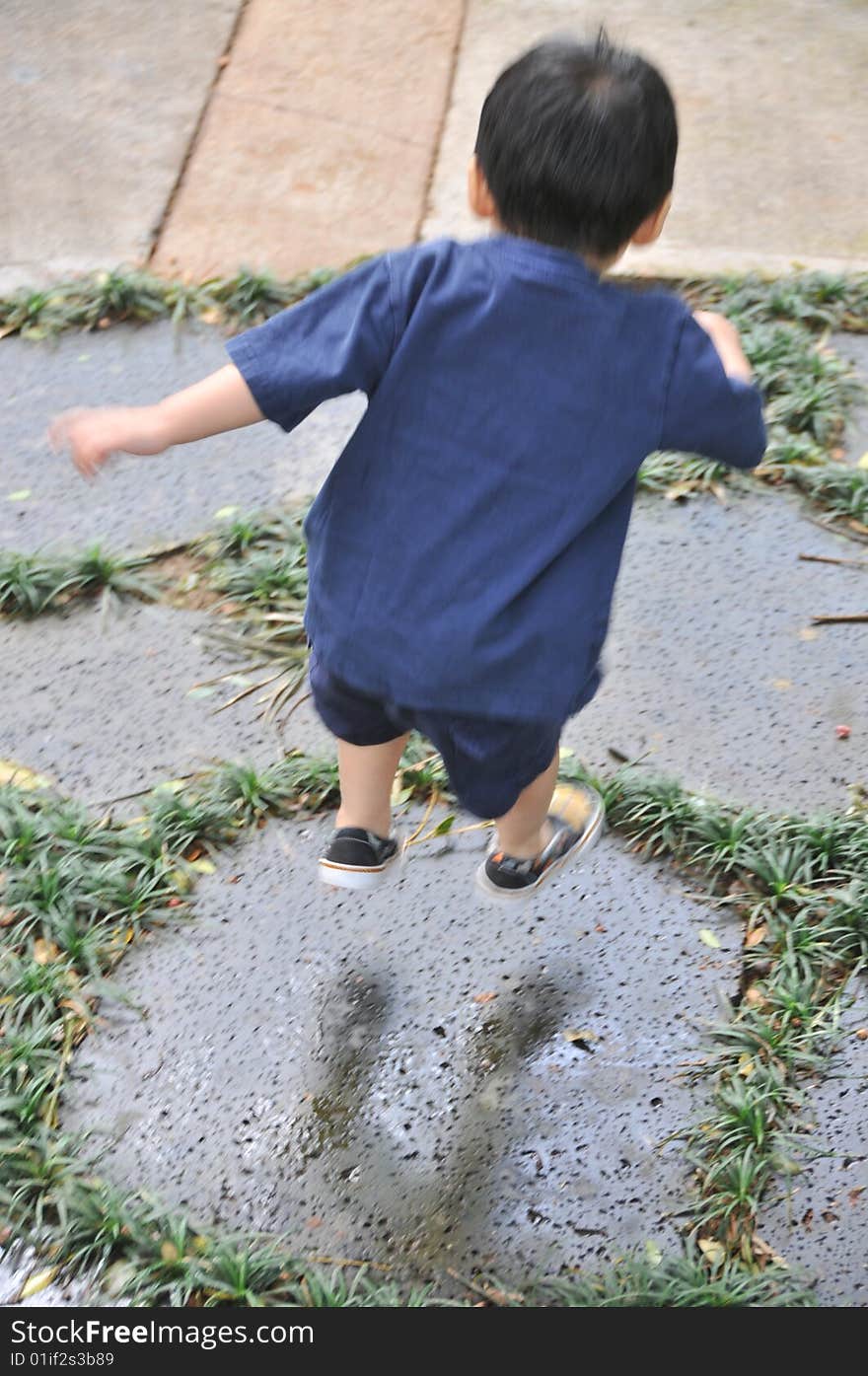 Jumping boy on stones