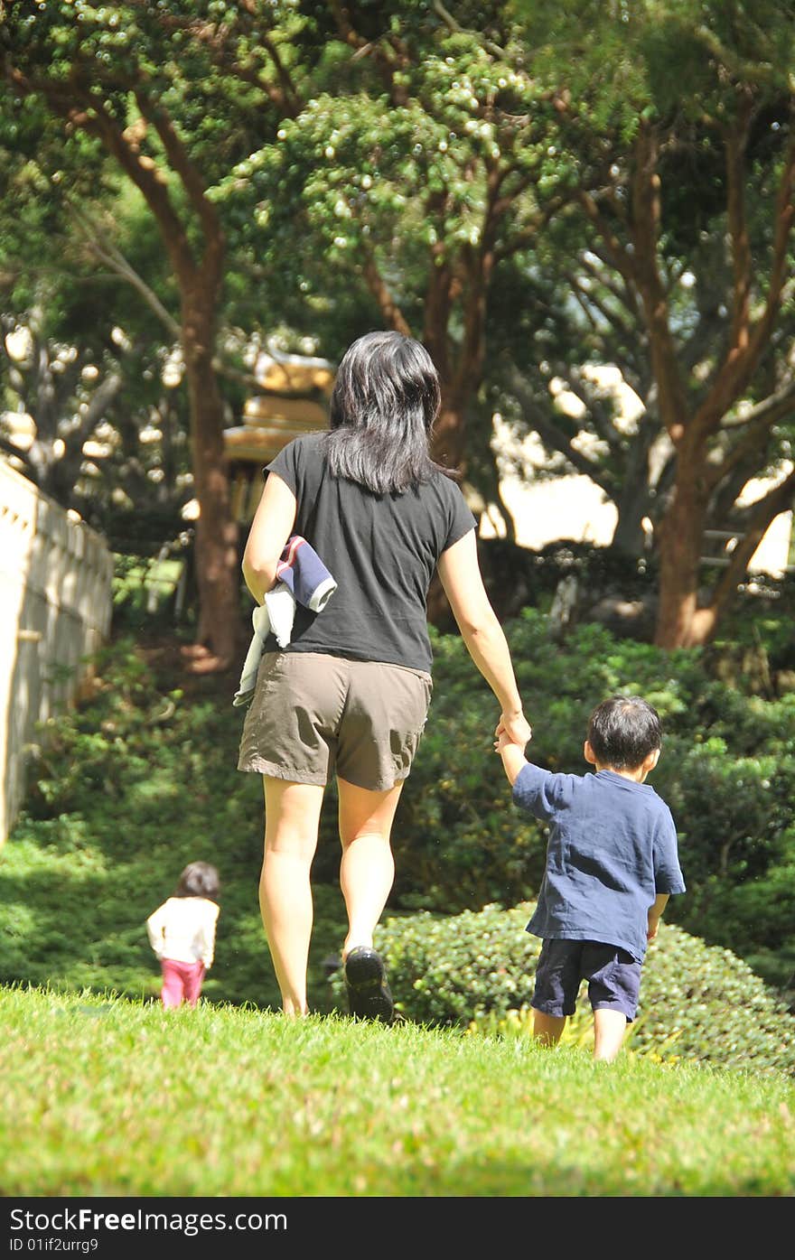 A family goes for a walk in a lush green area. A family goes for a walk in a lush green area