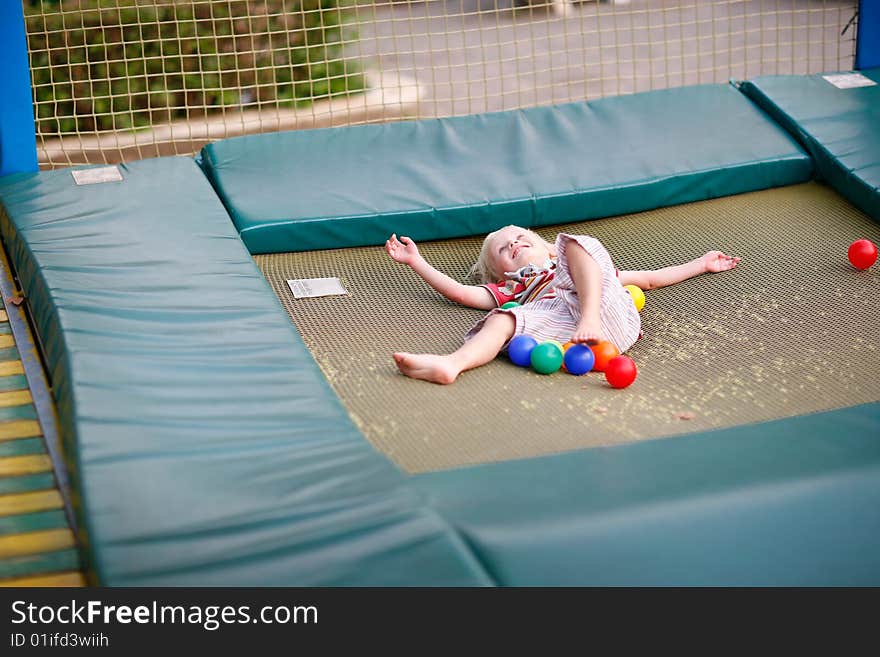 Little boy on a children's playground on a trampoline. Little boy on a children's playground on a trampoline