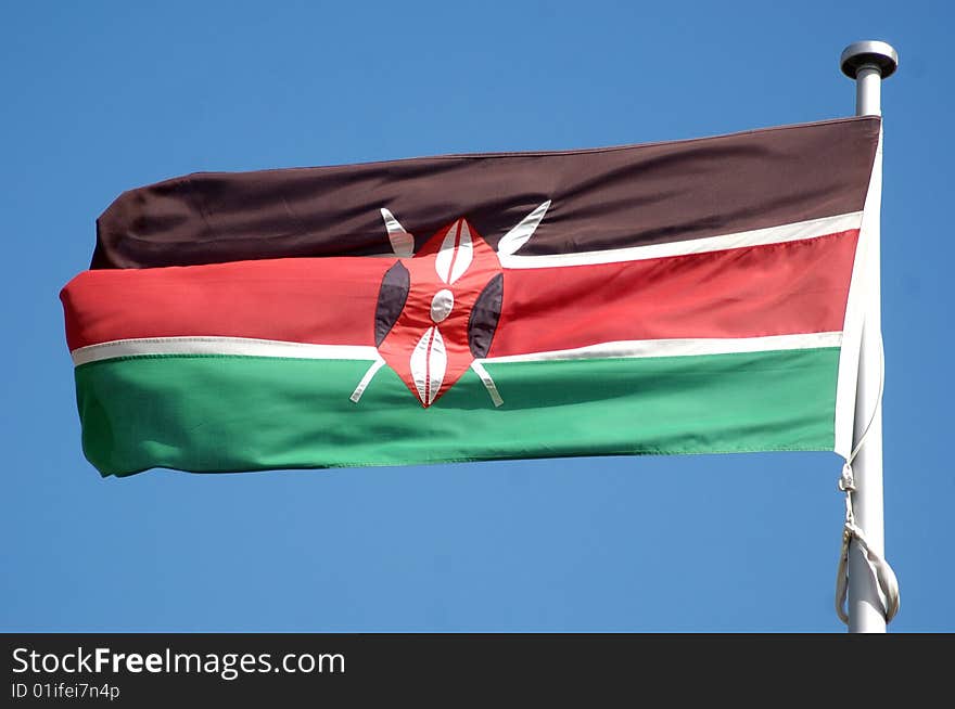 Kenyan flag against blue sky