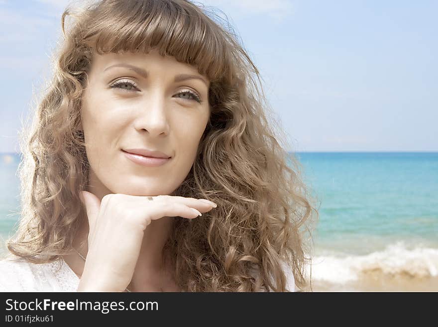 Portrait of nice young woman having good time on the beach. Portrait of nice young woman having good time on the beach