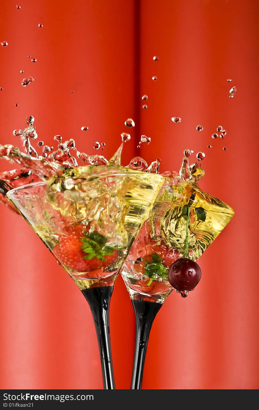 View of  martini glass with vermouth and berry dropping in. View of  martini glass with vermouth and berry dropping in