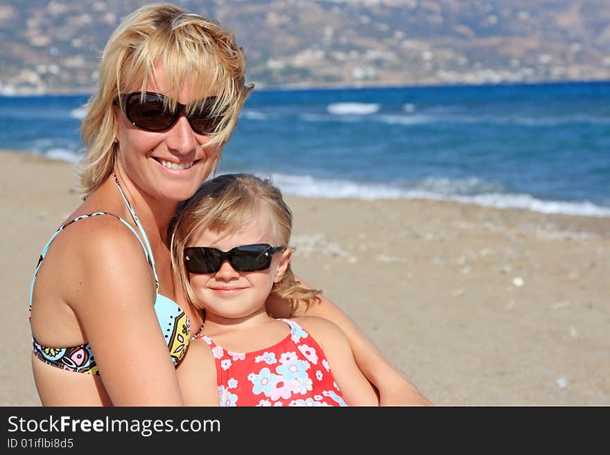 Happy mum with a daughter have a rest on the sea