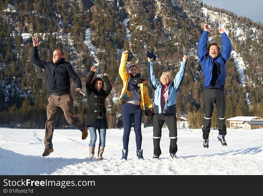 Family in a and outdoor winter setting. Jumping in joy! Slight motion bluriness is intended. Family in a and outdoor winter setting. Jumping in joy! Slight motion bluriness is intended.