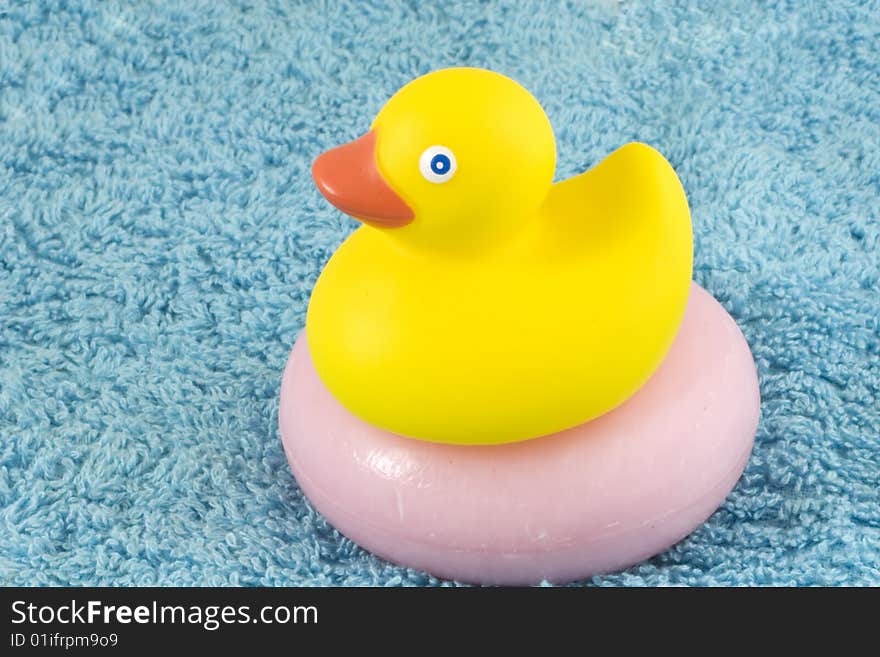 Classic rubber ducky on a pink bar of a scented soap