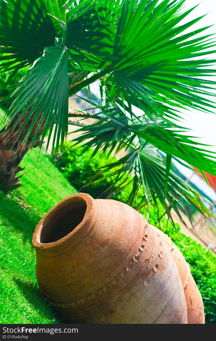 Large clay pitcher lying on grass. Large clay pitcher lying on grass