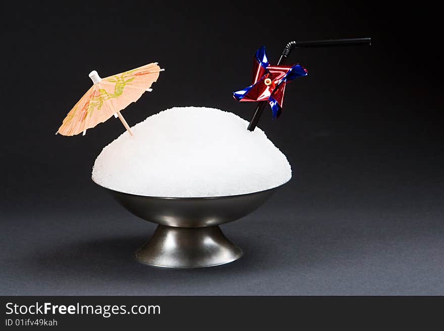 Snow in a cup for ice-cream isolated on a black background. Snow in a cup for ice-cream isolated on a black background