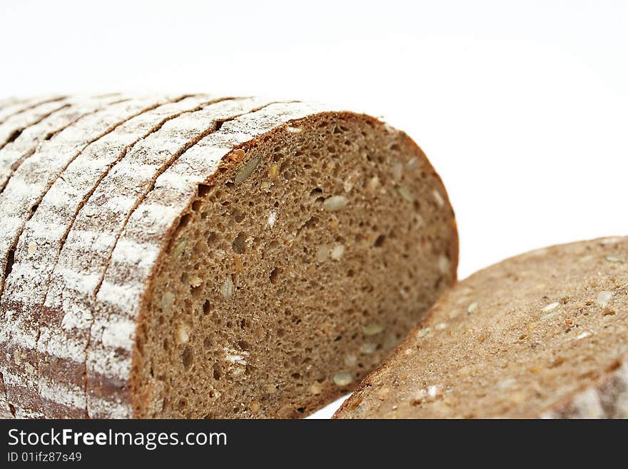 Sliced loaf of cereal bread on white background