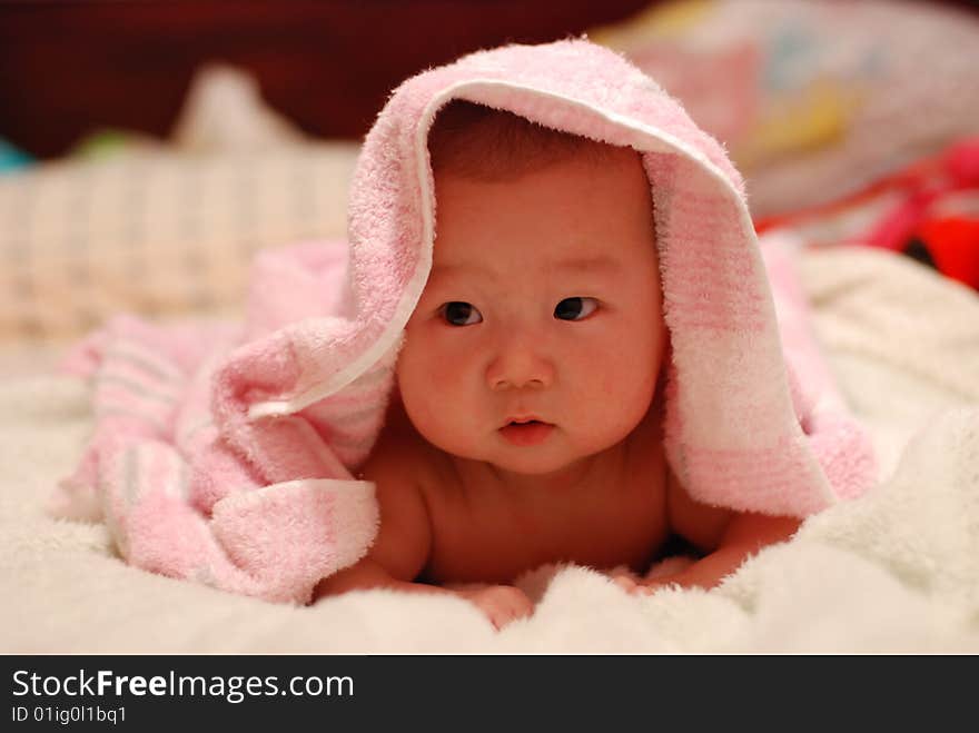 adorable baby boy over white quilt. adorable baby boy over white quilt