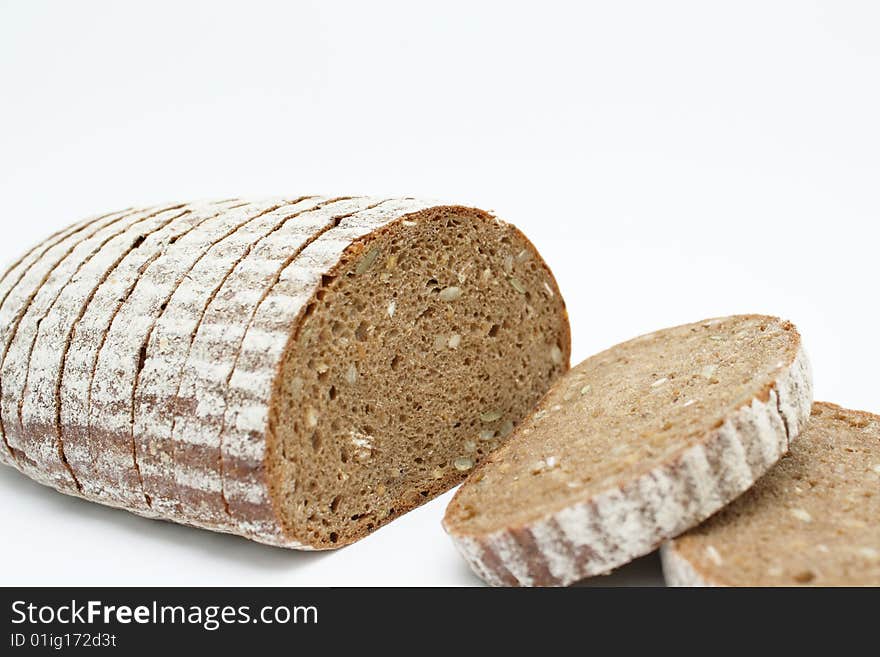 Sliced loaf of cereal bread on white background