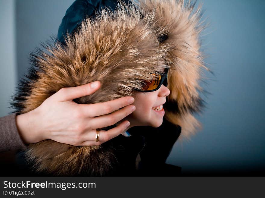 Child in jacket with fur hood. Child in jacket with fur hood