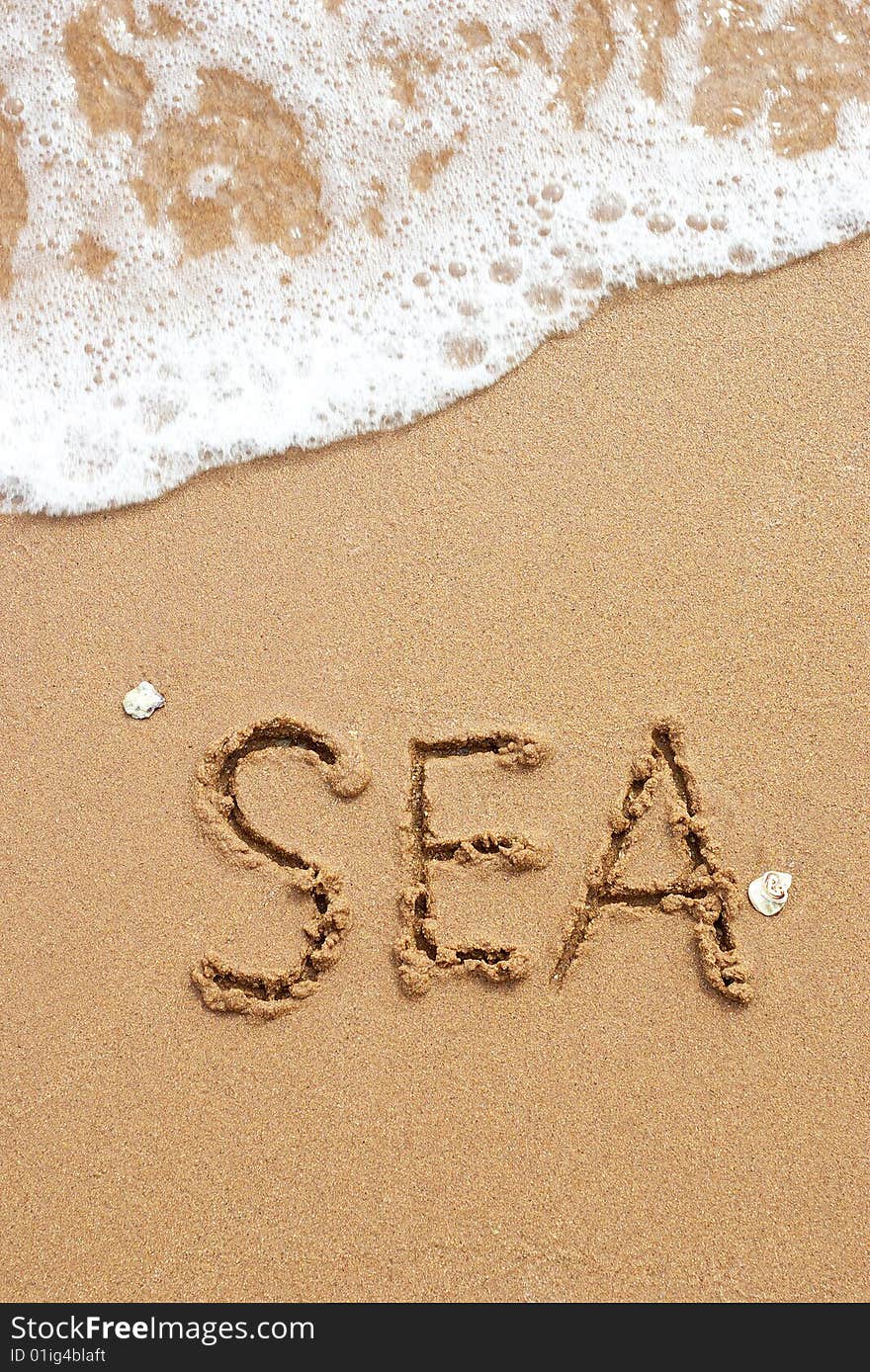 The word sea written on  sandl. The surf of the sea. The word sea written on  sandl. The surf of the sea