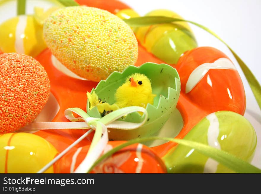 Egg shaped dish holding colorful Easter eggs