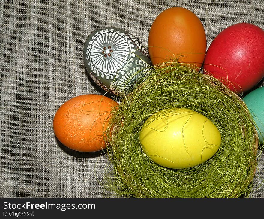 Different colour Easter eggs on linen background