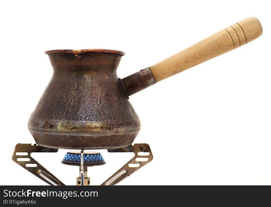 Coffe pot on a gas burner is isolated on a white background