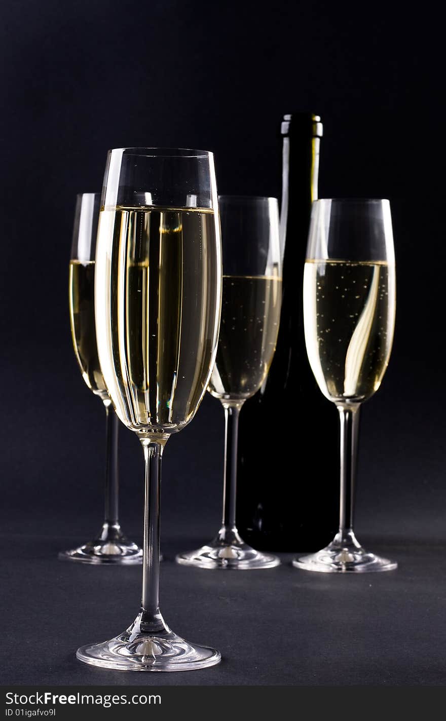 Champagne glass on black background