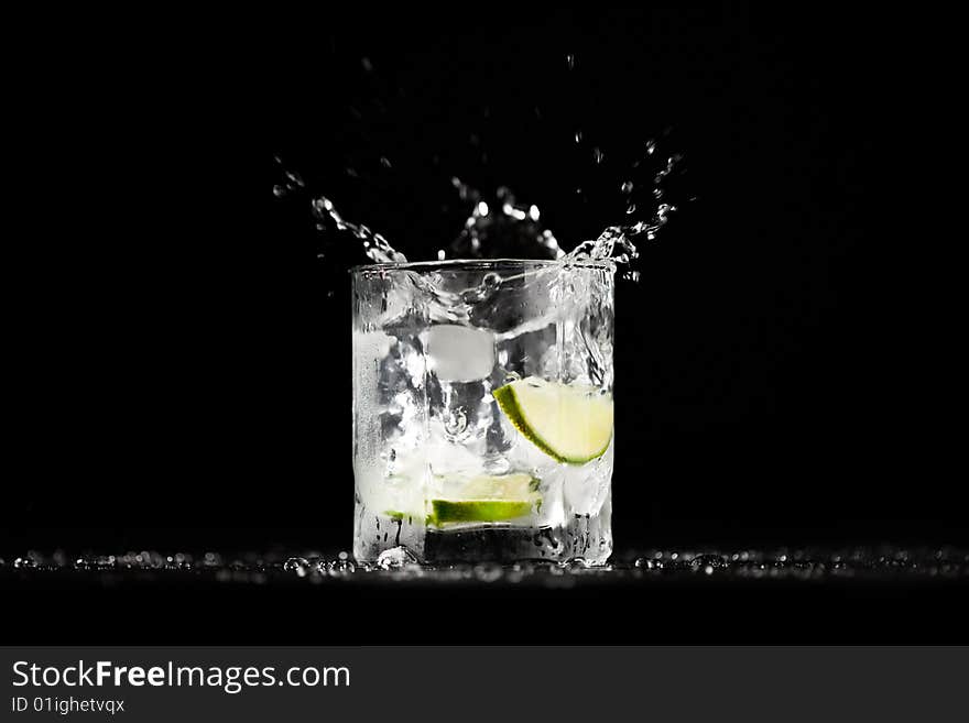 Ice water exploding in a tumbler with lime. Image series. Ice water exploding in a tumbler with lime. Image series.