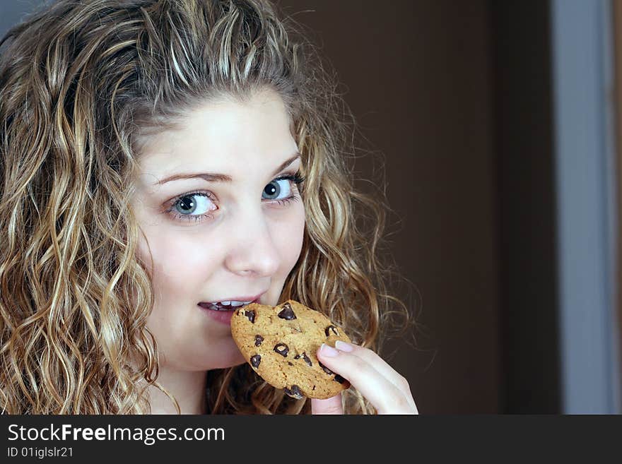 Girl eating chocolate cookie