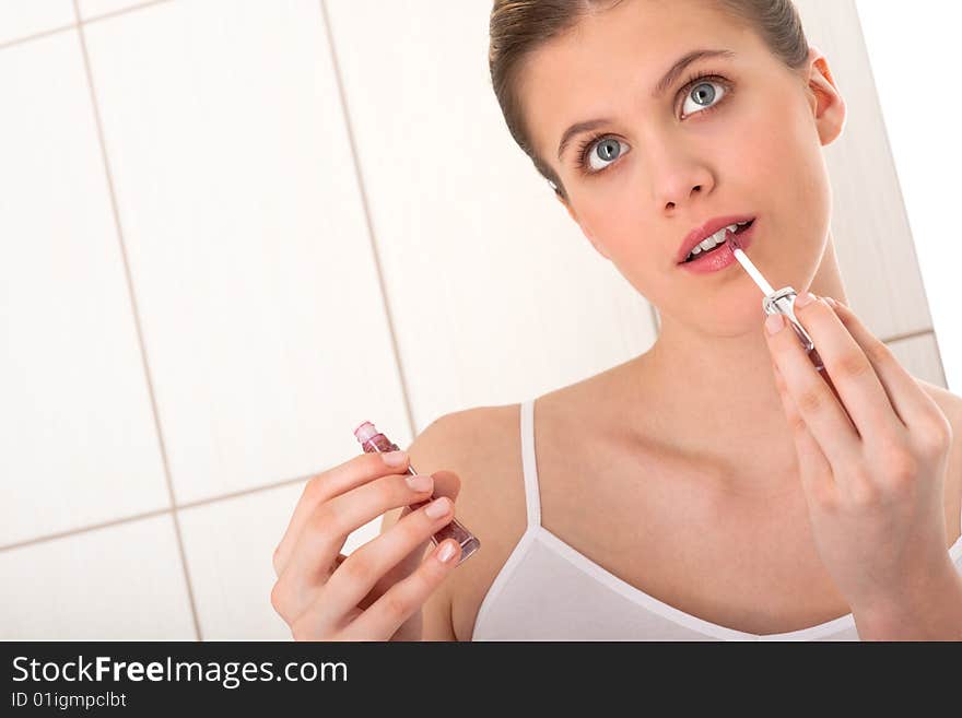 Body care - Young woman apply lipstick