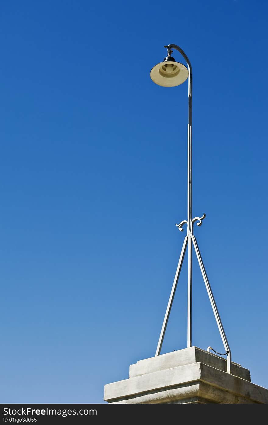 Retro streetlight against a clear blue sky