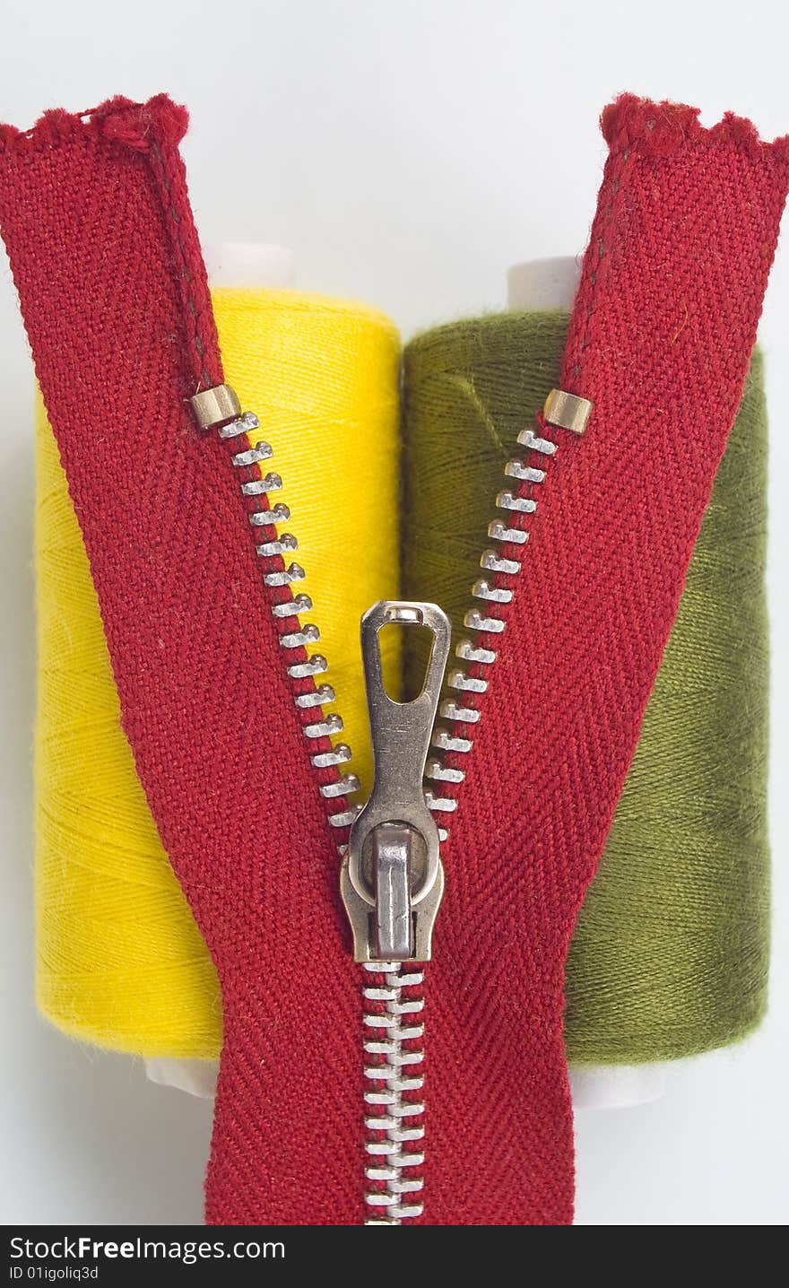 Two sewing spools with a zipper