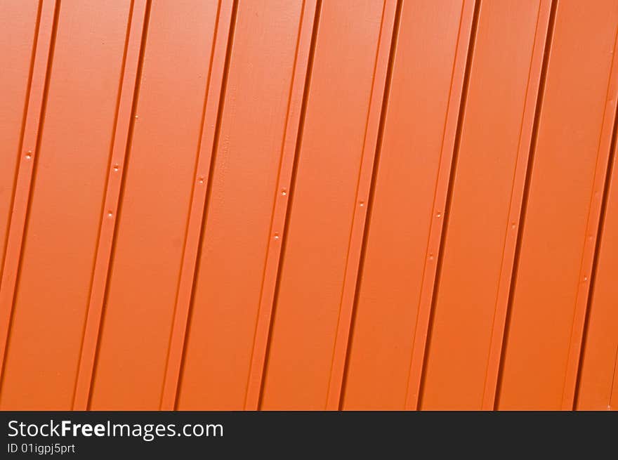 Corrugated metal panel painted in vivid orange. Corrugated metal panel painted in vivid orange.