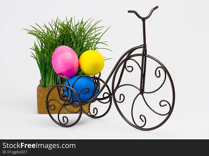 Dyed Easter eggs on vintage bike. Isolated studio shot.