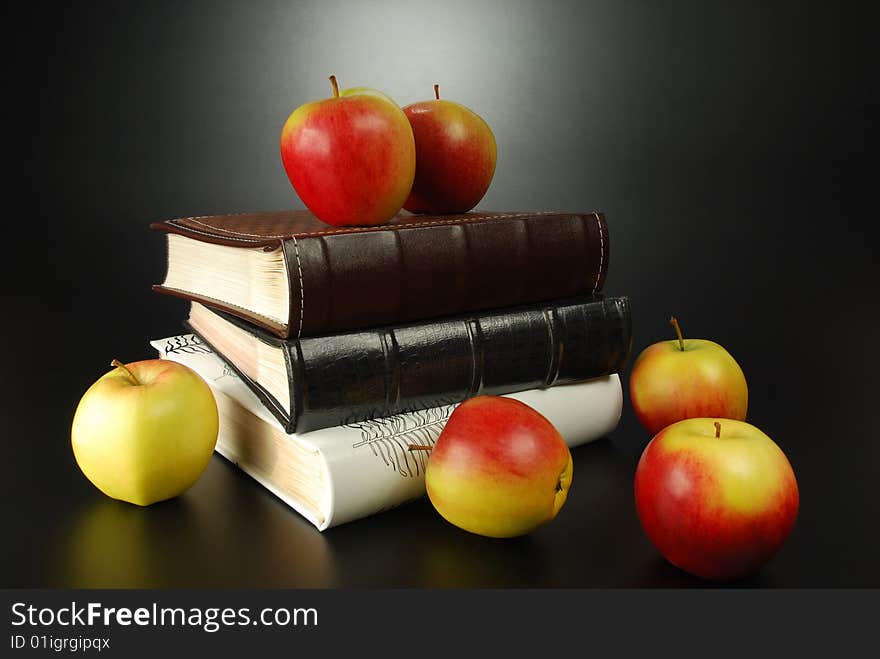 Apples and albums on a black background