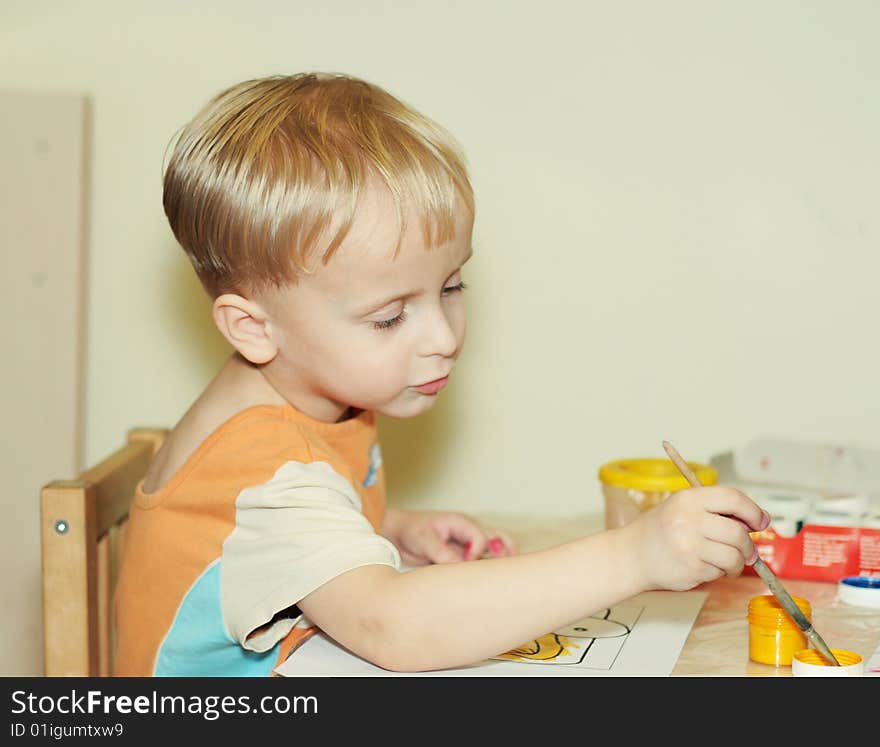 Toddler boy paints by gouache. Toddler boy paints by gouache