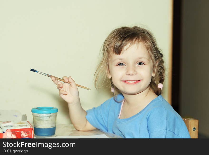 Toddler girl paints by gouache. Toddler girl paints by gouache