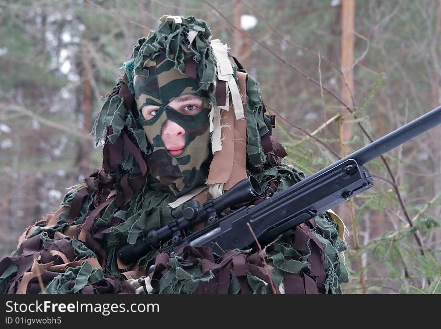 Man in a camouflage with a sniper gun