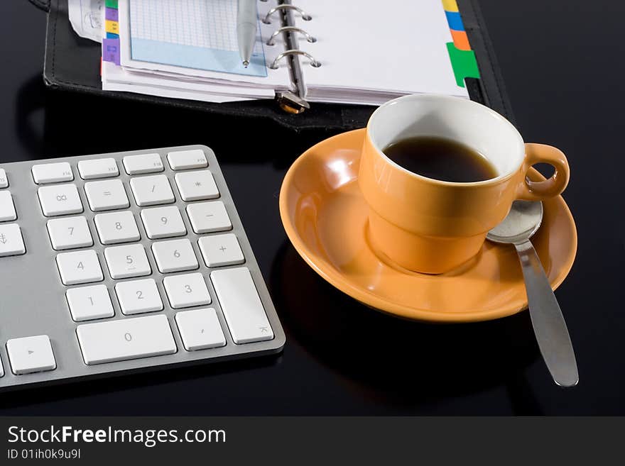 Keyboard coffee pen and notepad on black background. Keyboard coffee pen and notepad on black background